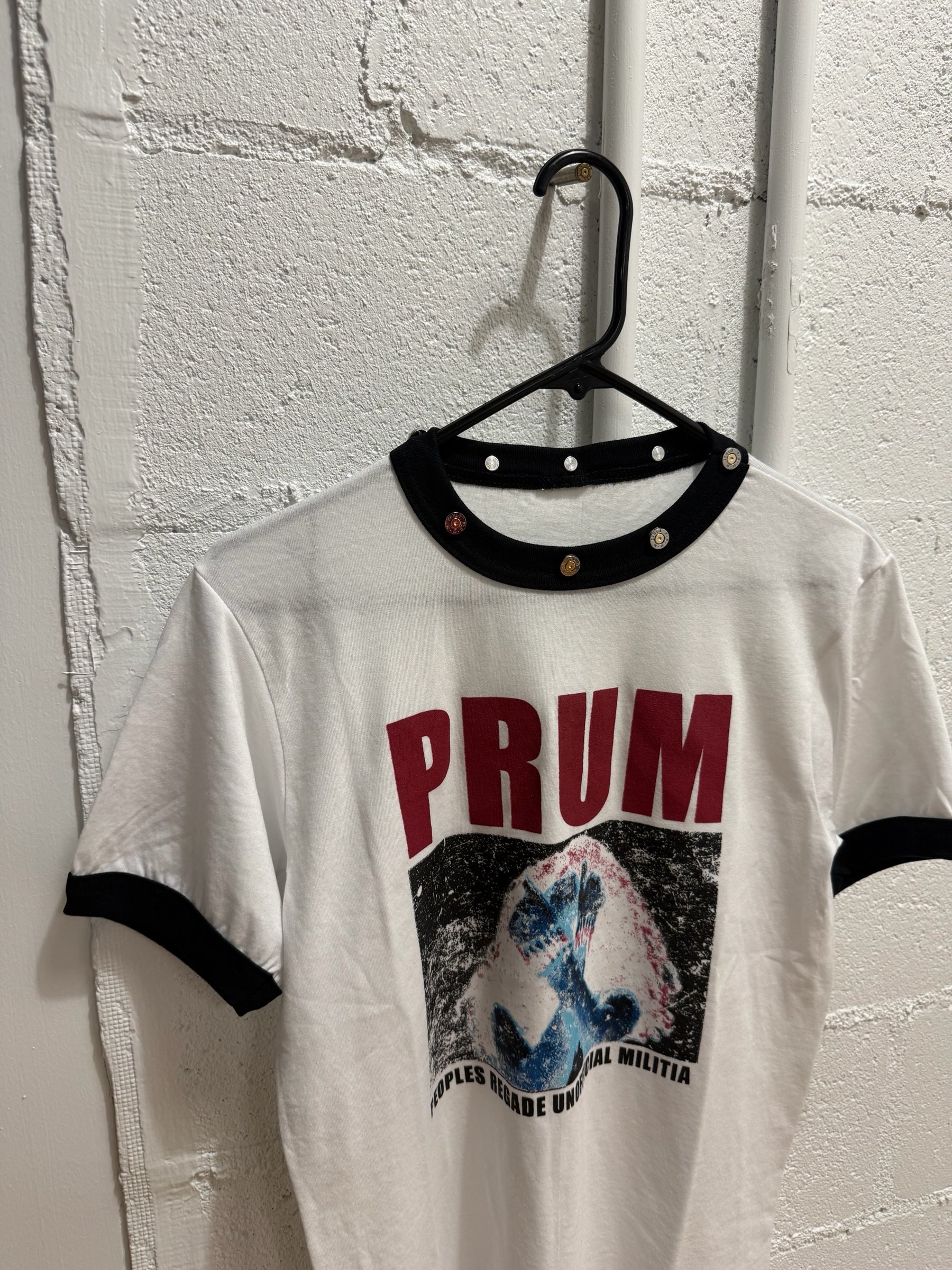 prum.online white cotton ringer t-shirt with black ribbed collar, metallic stud hardware, and distressed graphic print